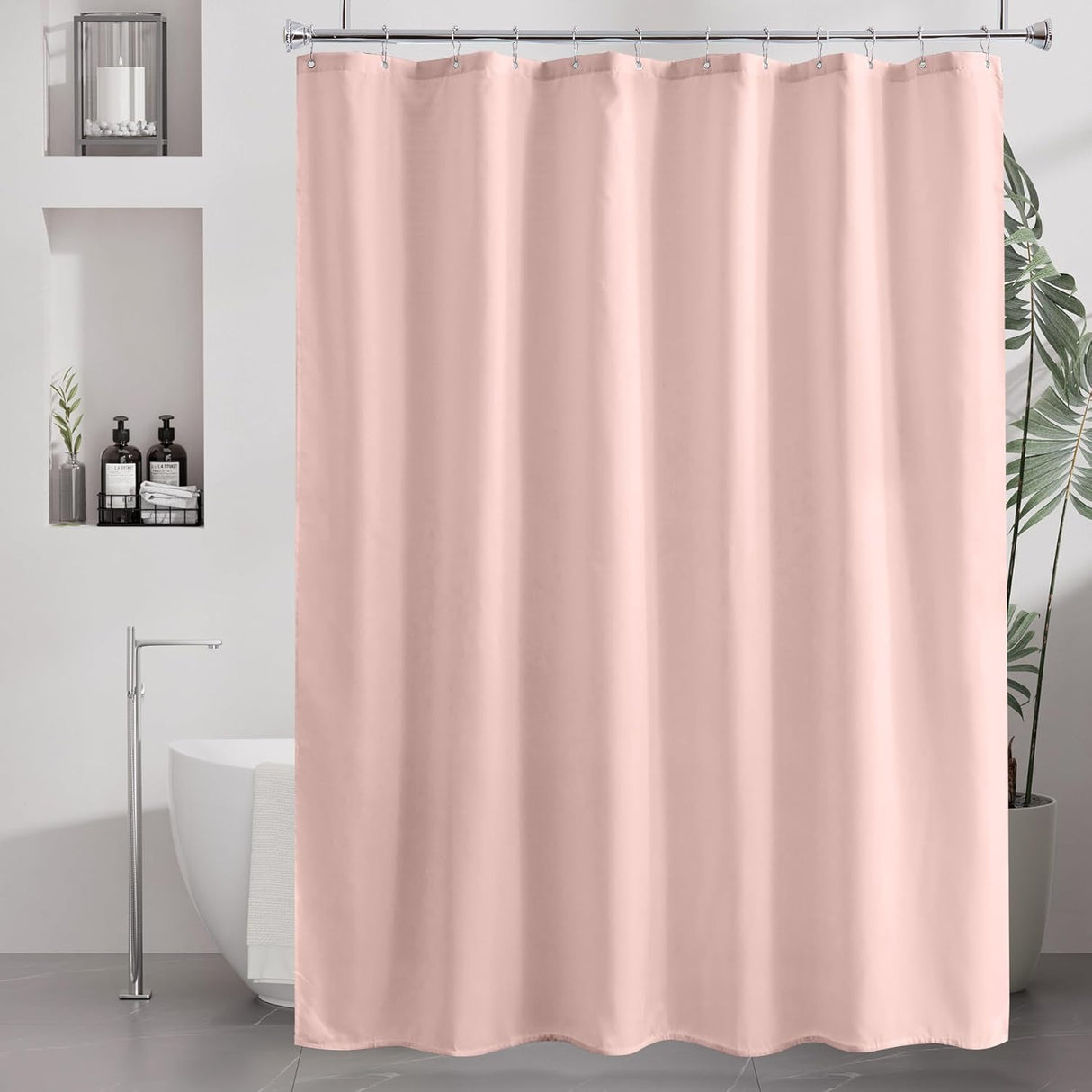 Pink shower curtain in a bathroom setting with a freestanding bathtub and decorative elements.