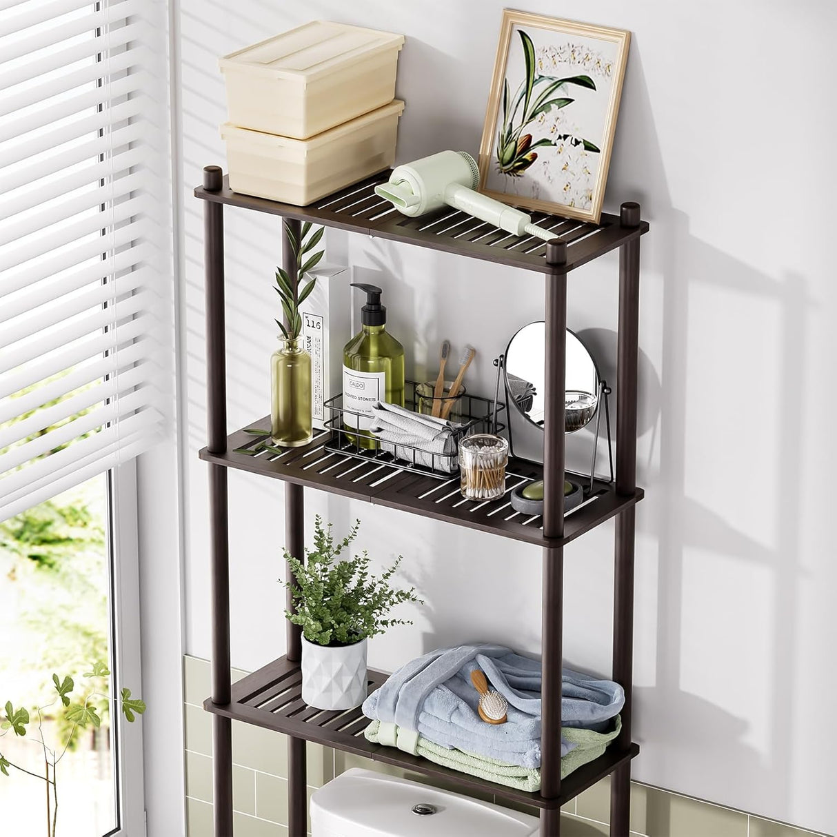 Three-tiered bamboo shelf with various items in a bathroom setting