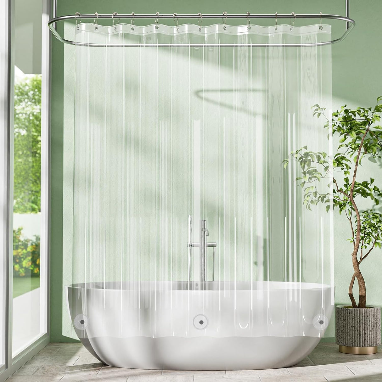 Modern bathroom with a freestanding bathtub, clear shower curtain, and greenery.