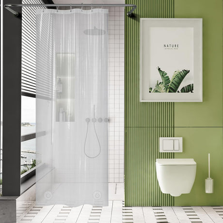 Modern bathroom with green tiled wall, white toilet, and shower curtain.