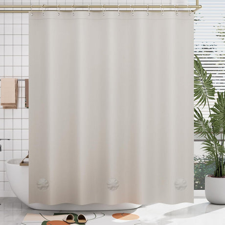 Beige shower curtain liner with leaf patterns in a bathroom setting
