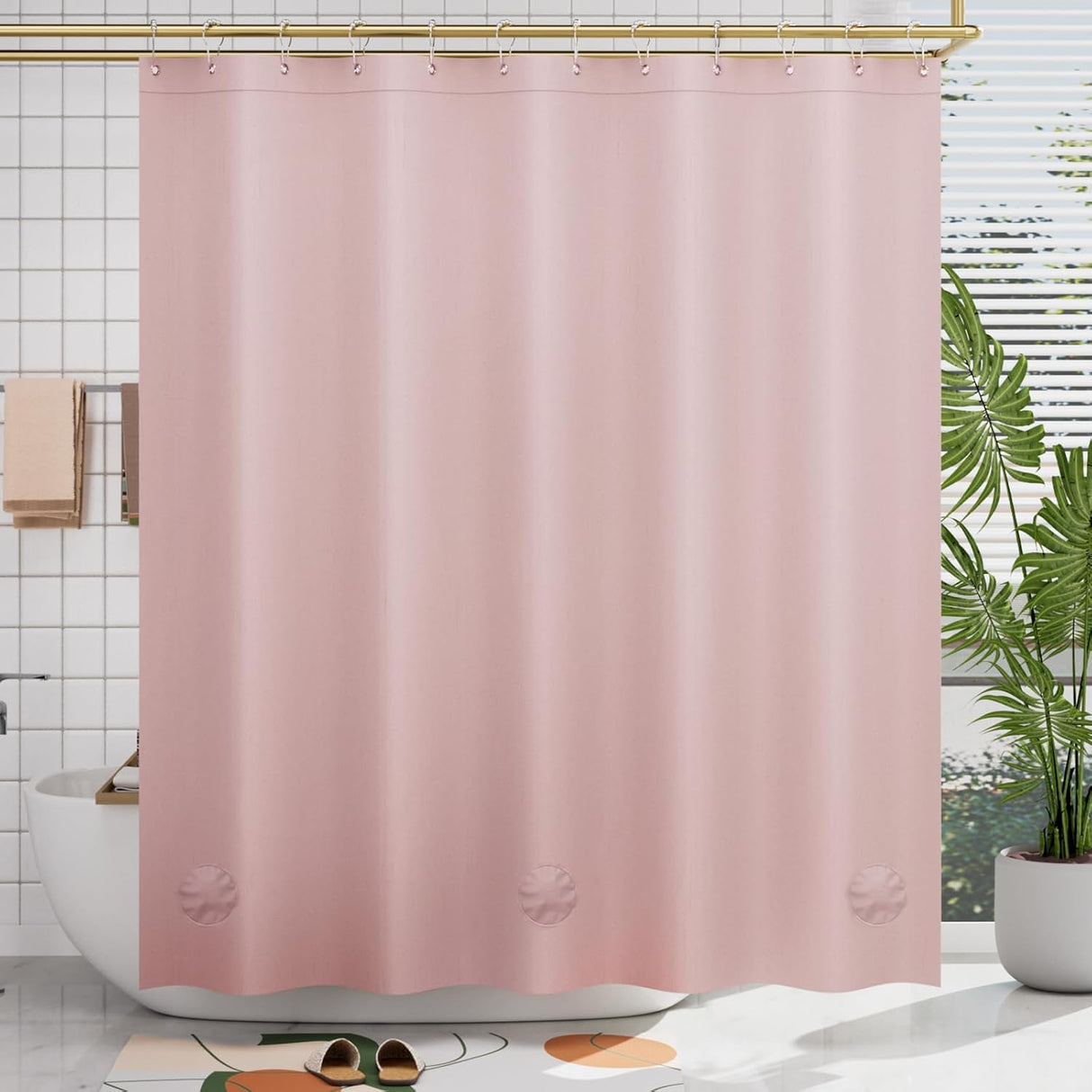 Pink shower curtain liner in a bathroom with a plant and bathtub.