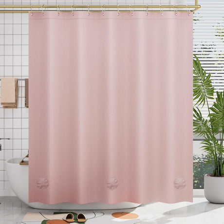 Pink shower curtain liner in a bathroom with a plant and bathtub.