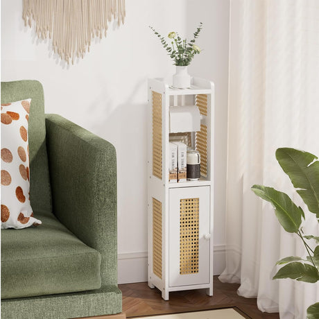 Green sofa with a decorative pillow next to a white cabinet with wicker doors in a room with curtains and a plant.