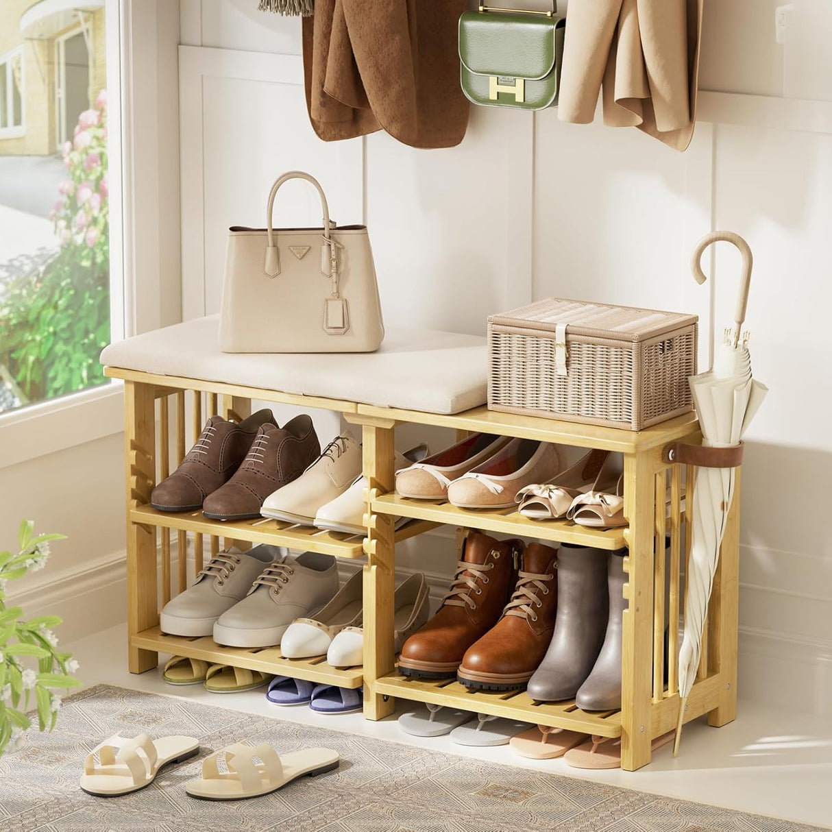 Bamboo shoe rack with shoes, handbag, and umbrella in a home setting.