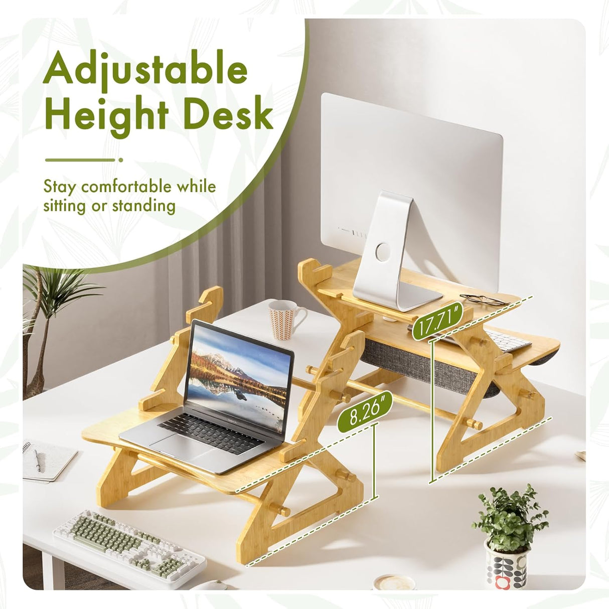 Adjustable height desk with laptop and computer monitor on a white desk.