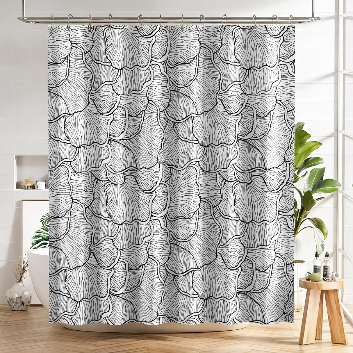 Shower curtain with black and white floral pattern in a bathroom setting