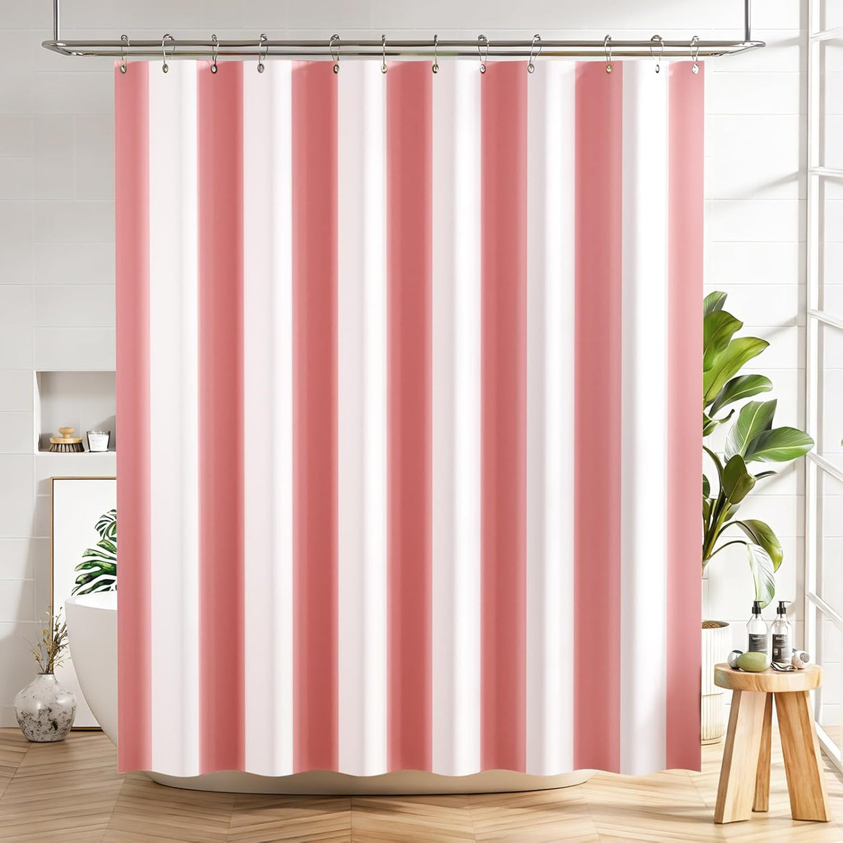 Striped pink and white shower curtain in a bathroom setting with plants and decor.