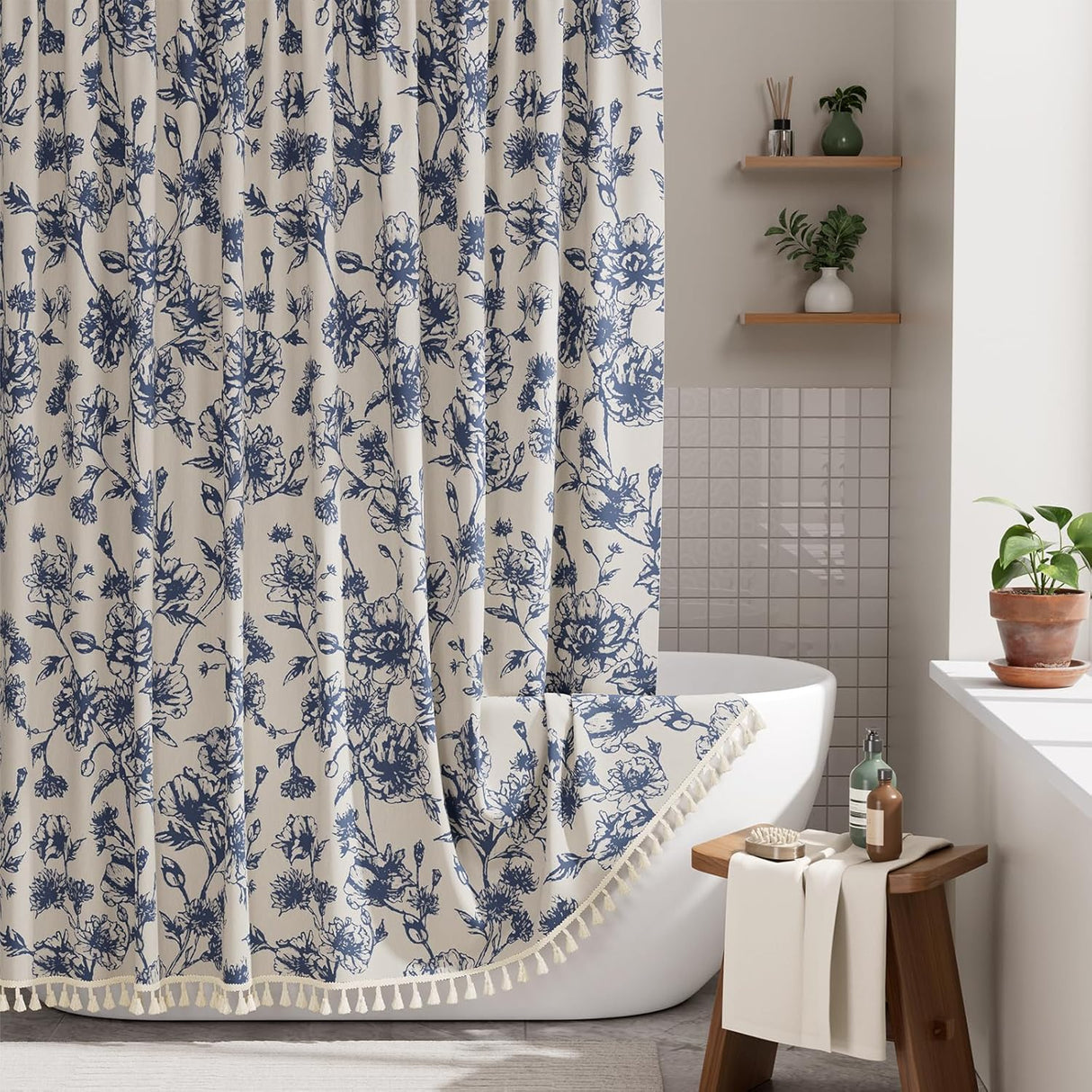 Floral shower curtain with blue flowers on a white background in a bathroom setting.