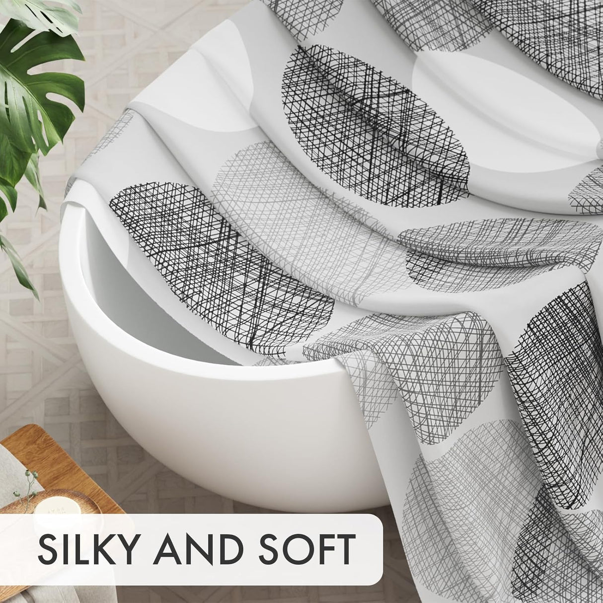 White bathtub with black geometric patterned towel draped over it, with text 'SILKY AND SOFT' at the bottom.