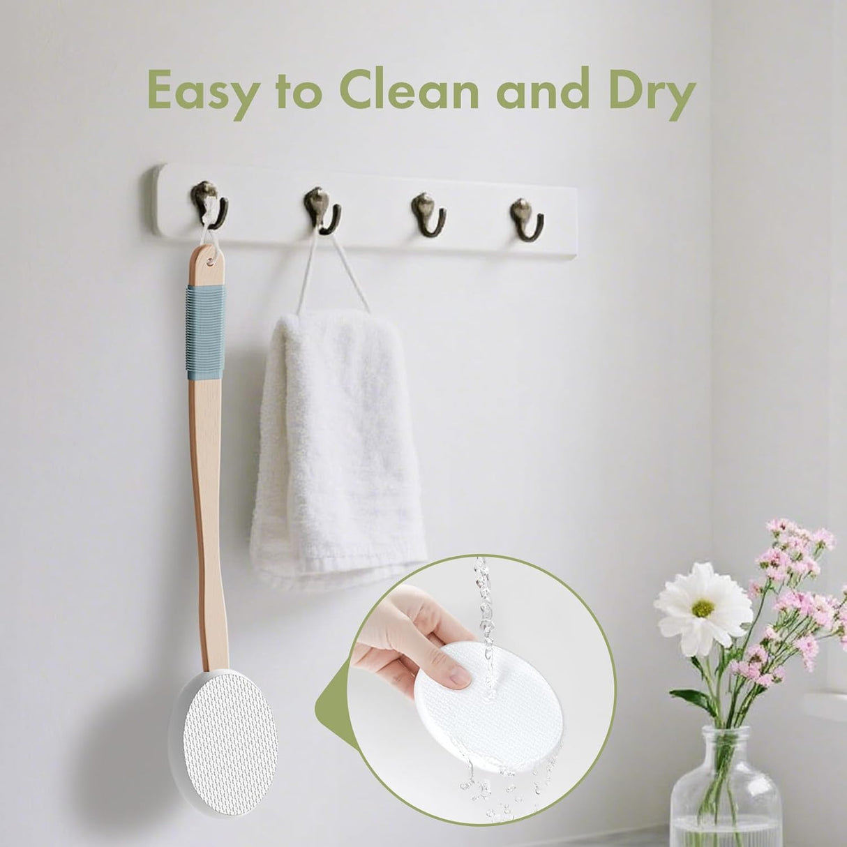 Wall-mounted hooks with a wooden spoon, towel, and small plant on a light gray wall.