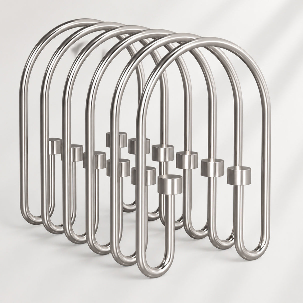 Metallic shower curtain hooks on a white background