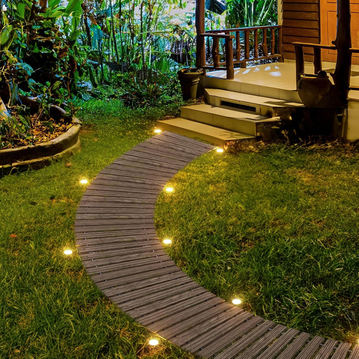 Wooden pathway winding through a garden with outdoor lighting