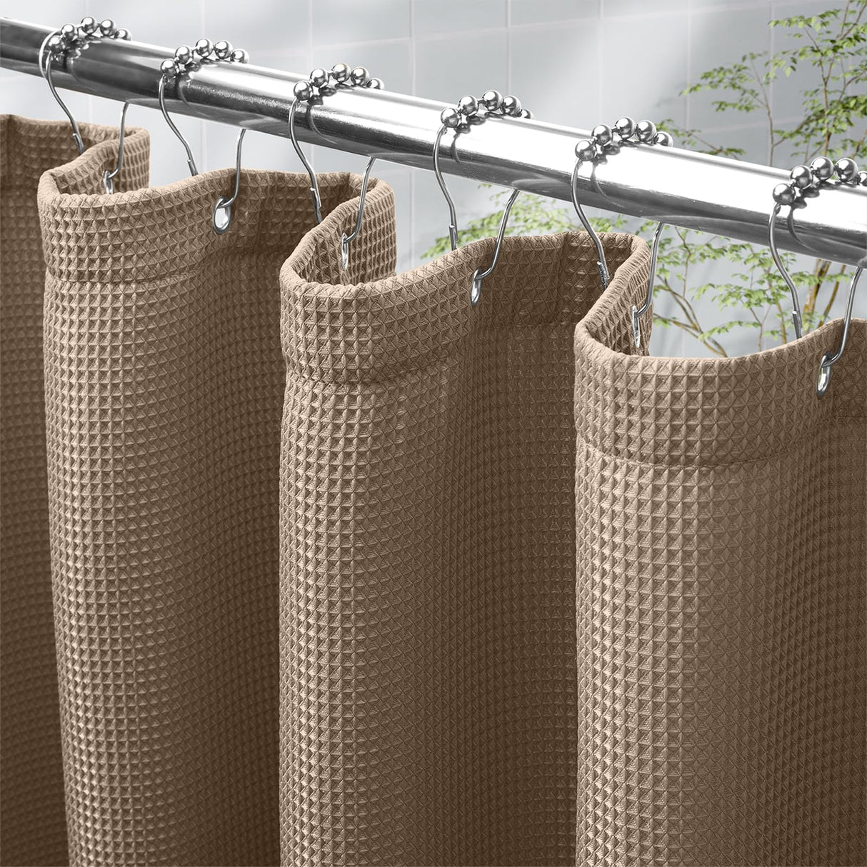 AmazerBath taupe waffle shower curtain in 240 GSM fabric hanging from silver hooks on a bathroom rod.
