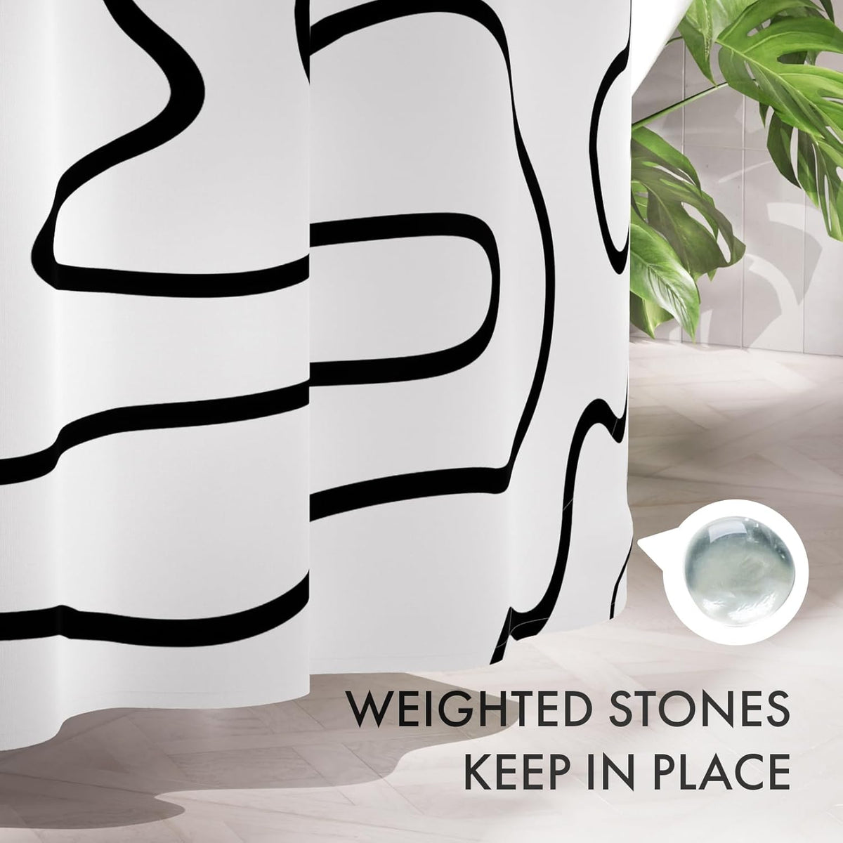 Weighted bottom system on the Black Abstract Shower Curtain with 12 Rings that helps keep it in place.