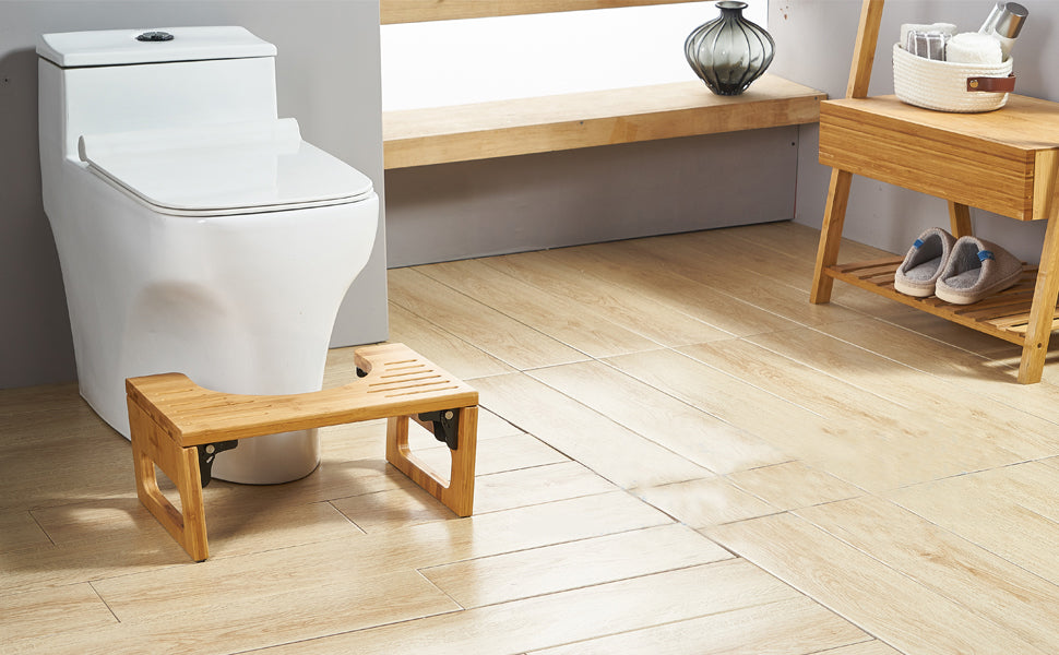 Bamboo toilet stool positioned in front of a bathroom toilet