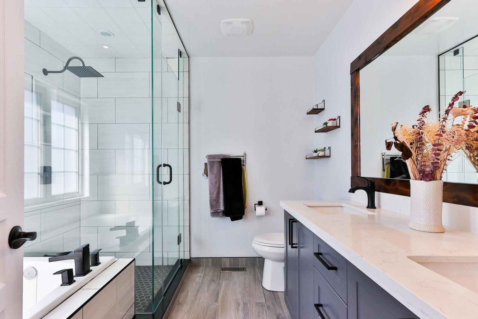 Clean ventilated bathroom with dry tile, shower surfaces, and natural light