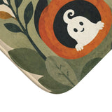 AmazerBath Halloween bath mat corner with green leaves, white ghost, and jack-o'-lantern, vivid print, soft texture, and a bound edge.