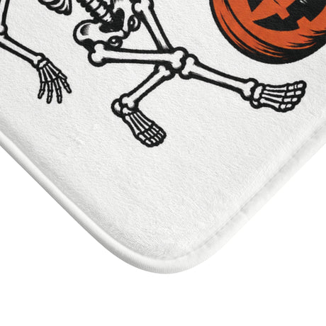 AmazerBath Halloween bath mat corner with dancing skeletons with jack-o'-lanterns, vivid print, soft texture, and a bound edge.