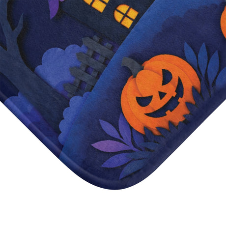 AmazerBath Halloween bath mat corner with haunted houses, full moon, and pumpkins, vivid print, soft texture, and a bound edge.