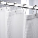 White shower curtain with silver hooks on a gray background