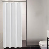 White shower curtain in a bathroom setting with tiled walls and a toilet.
