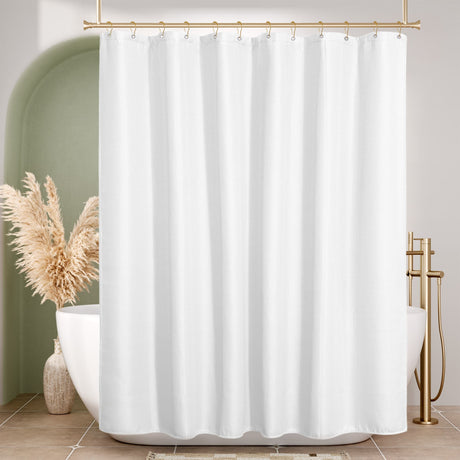 Waffle White shower curtain in a bathroom with gold fixtures and pampas grass decor.