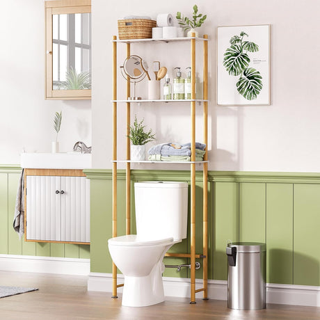 Bathroom with a toilet, over-the-toilet shelving unit, and decorative elements.