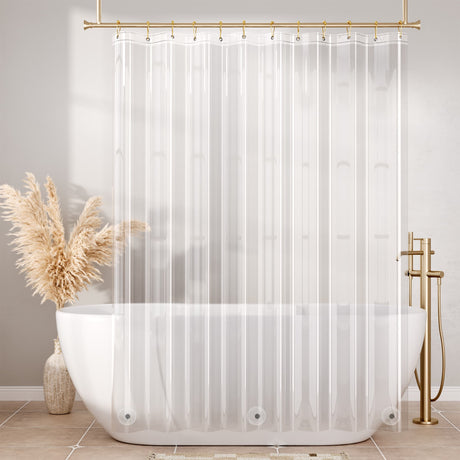 Clear shower curtain with a white bathtub and gold fixtures in a bathroom setting.