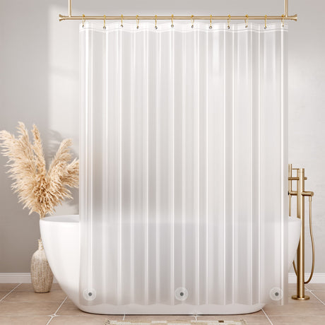 Frosted shower curtain liner with gold fixtures in a bathroom setting
