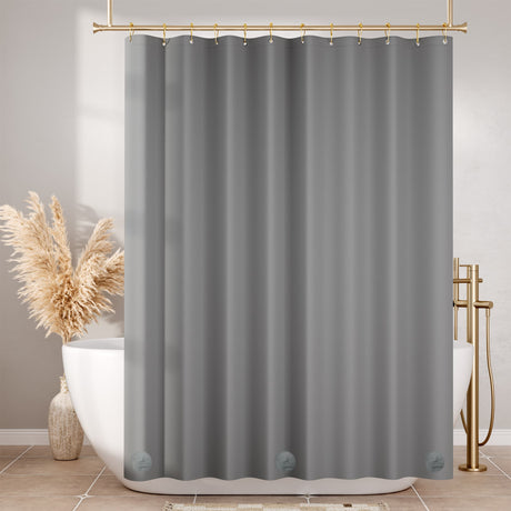 Gray shower curtain hanging in a bathroom with a bathtub and decorative elements.