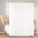 White shower curtain with gold fixtures in a bathroom setting