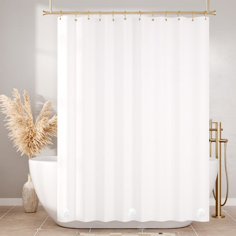White shower curtain with gold fixtures in a bathroom setting