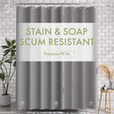 Gray shower curtain with 'Stain & Soap Scum Resistant' text in a bathroom setting