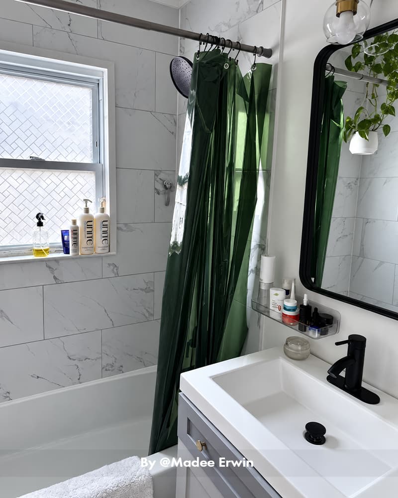 AmazerBath green lightweight 3G PEVA shower curtain liner hanging beside a bathtub, vanity, and bathroom window.