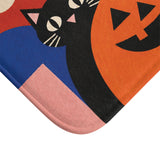 AmazerBath Halloween bath mat close-up with retro black cat, white ghost, and pumpkin, soft texture, and a rounded bound edge.