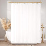 White shower curtain with gold fixtures and decorative elements in a bathroom setting.