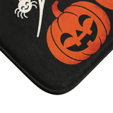 AmazerBath Halloween bath mat corner with spiderweb, bats, and three jack-o'-lanterns, vivid print, soft texture, and a bound edge.