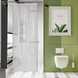 Modern bathroom with green tiled wall, white toilet, and shower curtain.