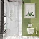 Modern bathroom with green tiled wall, white toilet, and shower curtain.