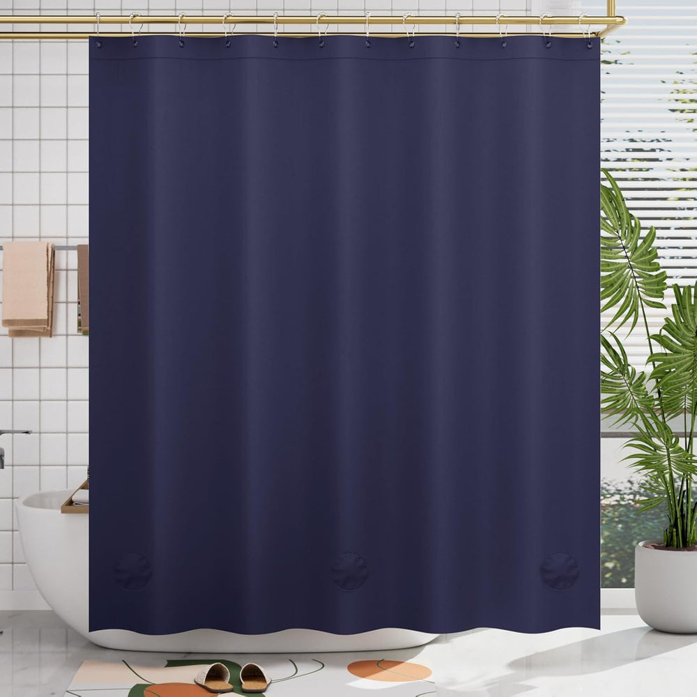 Navy blue shower curtain in a bathroom setting with a plant and bathtub.