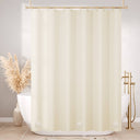 Beige shower curtain in a bathroom with a bathtub and decorative elements.