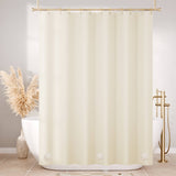 Beige shower curtain in a bathroom with a bathtub and decorative elements.