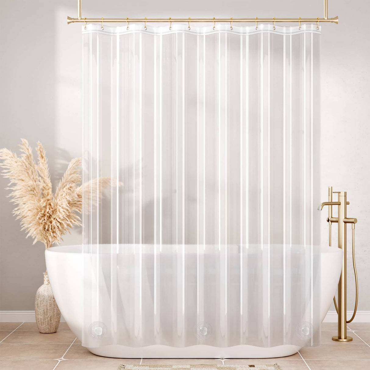 Clear shower curtain in a bathroom with a white bathtub and gold fixtures.