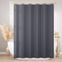 Gray shower curtain in a bathroom with a bathtub and decorative elements.