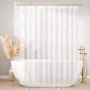 White shower curtain with gold fixtures in a bathroom setting