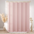 Pink shower curtain in a bathroom with a bathtub and decorative elements.