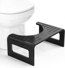 Black step stool in front of a white toilet on a white background