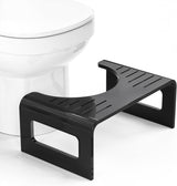 Black step stool in front of a white toilet on a white background