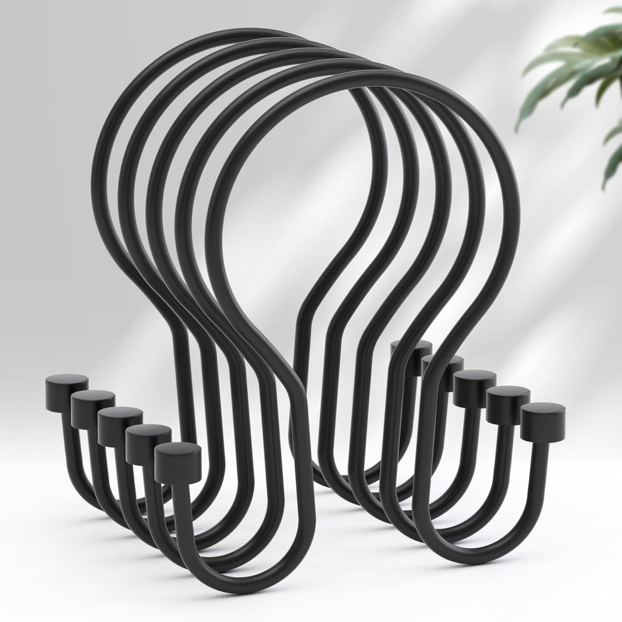 Set of black metal hooks on a white background